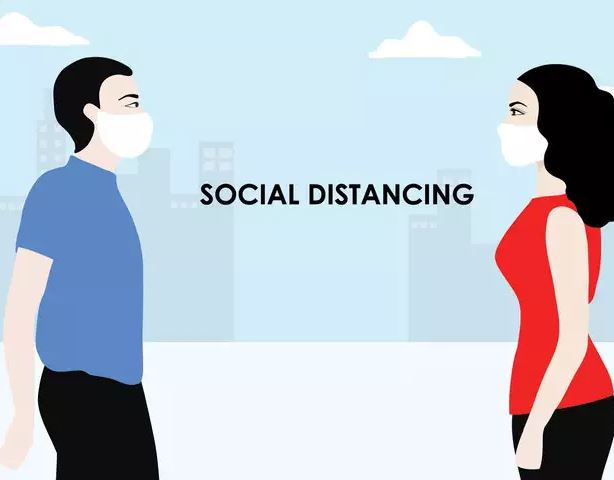 two people social distancing with the word between them