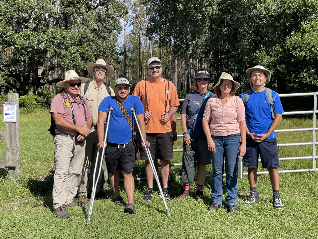 members of the district 5 neighborhood advisory council pose in front of a trail