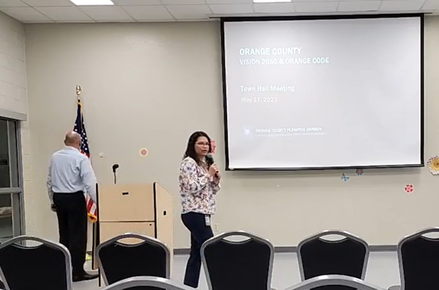 Commissioner Emily Bonilla addresses the Vision 2050 event from the front of the room.