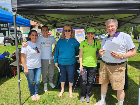 Commissioner Emily Bonilla is photographed with four volunteers at the District 5 tent during the 18th Annual Central Florida Earth Day Celebration.