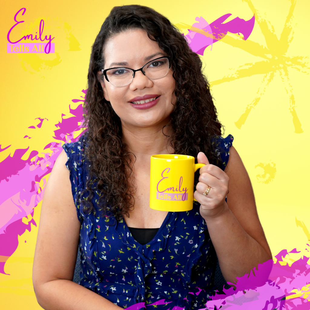Commissioner Bonilla smiles for a photo holding a Emily Tells All mug to promote her talkshow.