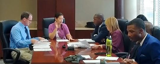 Photo of Commissioner Emily Bonilla, Commissioner Michael "Mike" Scott and Commissioner Maribel Gomez Cordero in the meeting room.
