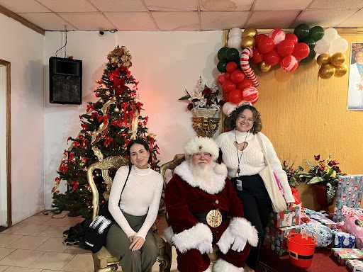 Commissioner Emily Bonilla's aides posing with Santa Clause at the New Image Youth Center Holiday Party.