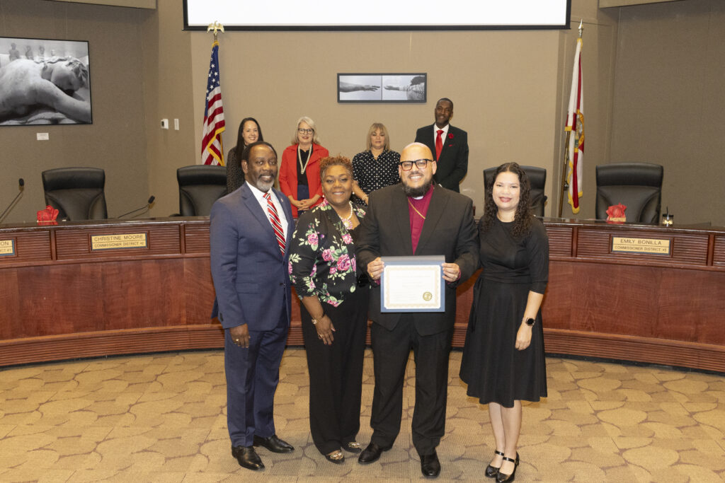 Bishop David Maldonado and his wife Theresa pose with Commissioner Emily Bonilla and Mayor Demings at the December 12 BCC Meeting.