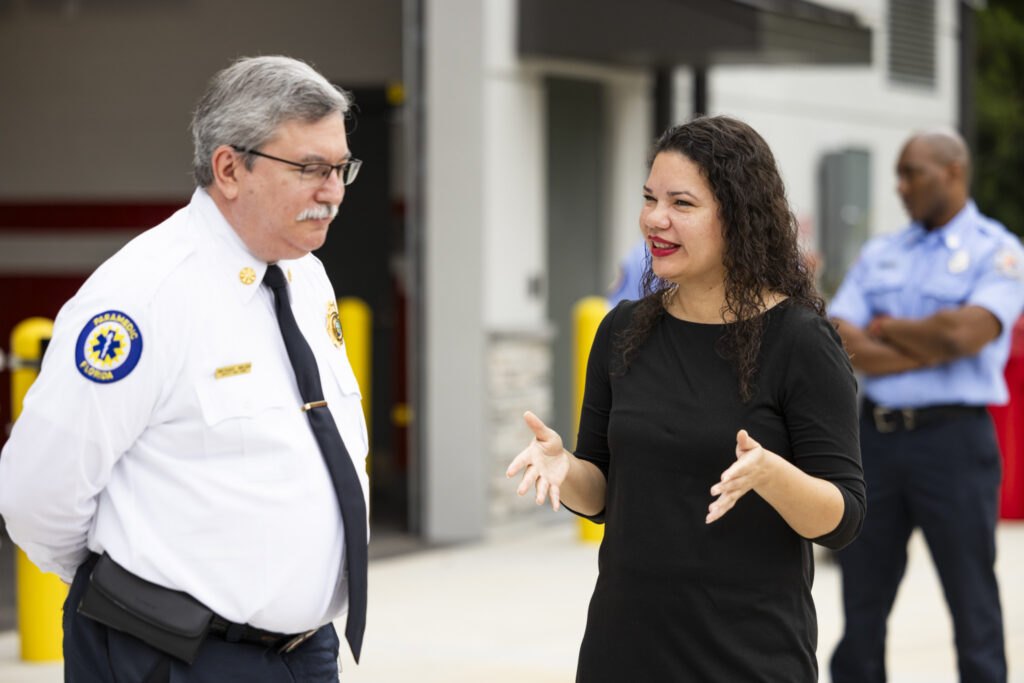 photograph of Commissioner Bonilla speaking with a member of Fire Station 80