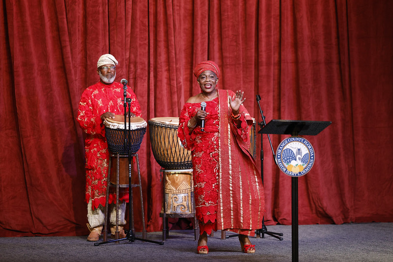 photograph of a man and woman performing traditional music at the Juneteenth Celebration