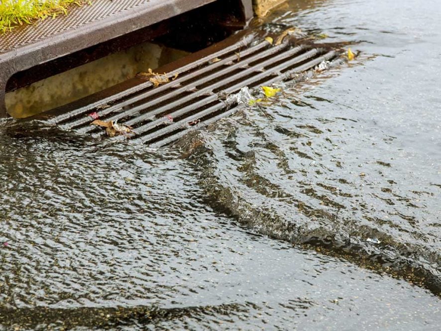 photograph of water going down a drain