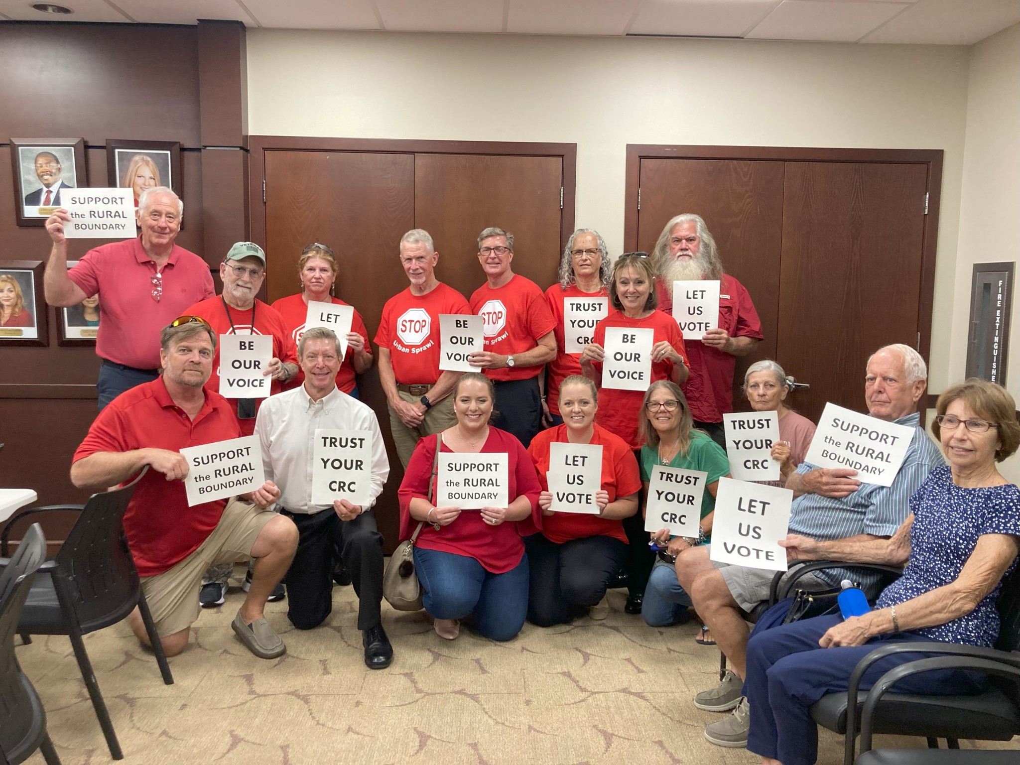 group of citizens with save rural boundary signs