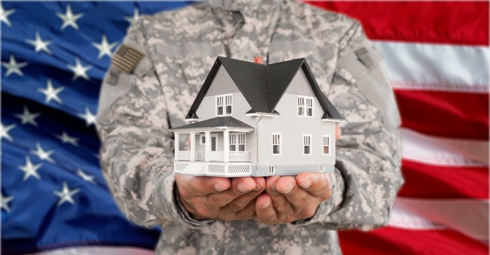 image of a veteran holding a model house